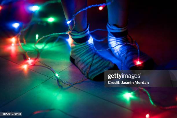 little boy feet with light cable - feet christmas stock-fotos und bilder