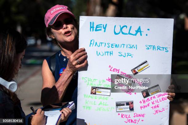 Protester holds a sign during a protest against anti-Semitism and the upcoming National Students for Justice in Palestine conference at the UCLA...