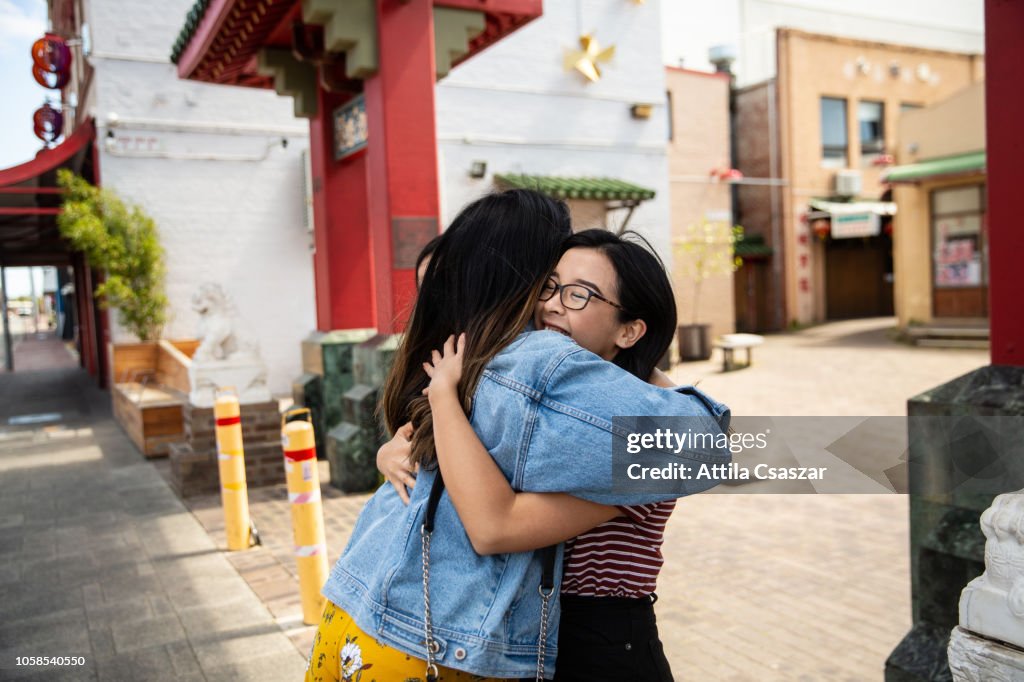 Happy greetings of young women in Chinatown