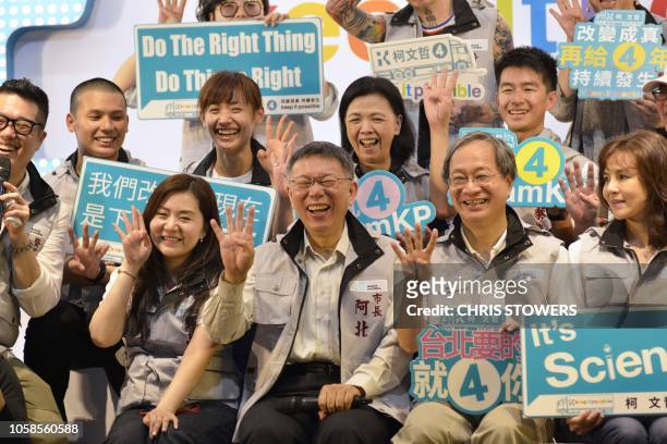 Taipei Mayor Ko Wen-je , who is seeking re-election, poses for a group photo during a campaign event with grassroots supporters in Taipei on November...