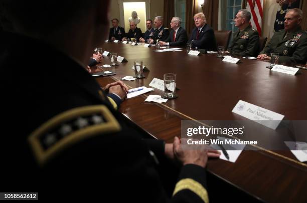 President Donald Trump answers questions during a meeting with military leaders in the Cabinet Room on October 23, 2018 in Washington, DC. Trump...