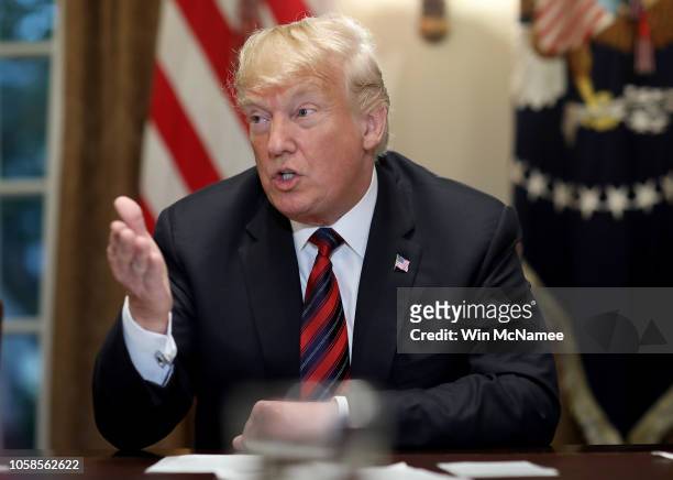 President Donald Trump answers questions during a meeting with military leaders in the Cabinet Room on October 23, 2018 in Washington, DC. Trump...