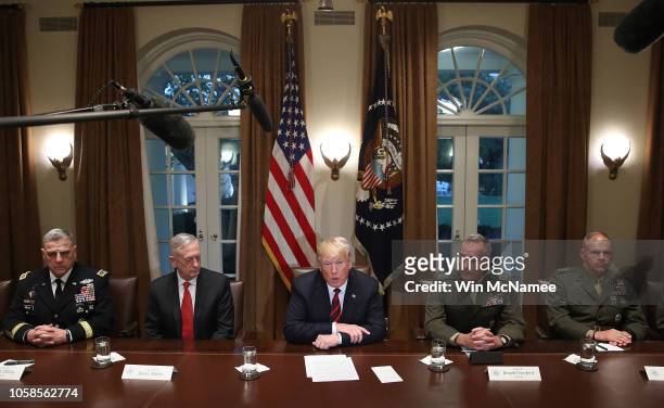 President Donald Trump answers questions during a meeting with military leaders in the Cabinet Room on October 23, 2018 in Washington, DC. Trump...