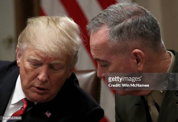 President Donald Trump confers with Chairman of the Joint Chiefs of Staff Joseph Dunford during a meeting with military leaders in the Cabinet Room...