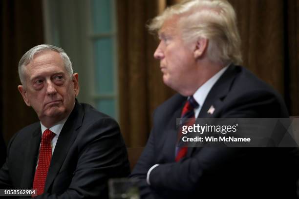 Defense Secretary Jim Mattis listens as U.S. President Donald Trump answers questions during a meeting with military leaders in the Cabinet Room on...