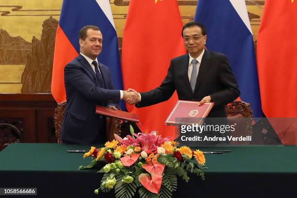 Chinese Premier Li Keqiang and Russian Prime Minister Dmitry Medvedev shake hands during the signing ceremony at The Great Hall Of The People on...