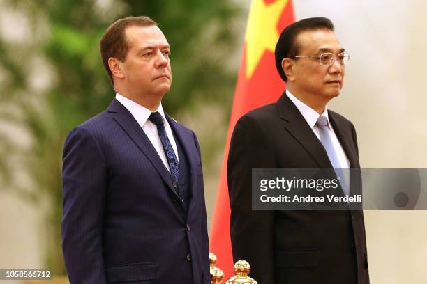 Chinese Premier Li Keqiang and Russian Prime Minister Dmitry Medvedev listen to their national anthems during the welcoming ceremony at The Great...