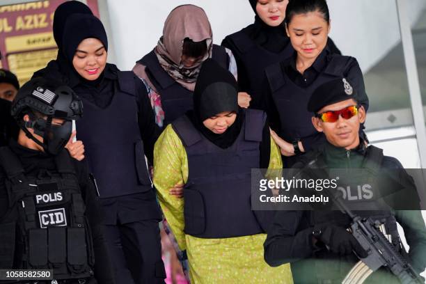 Indonesian Siti Aisyah and Vietnamese Doan Thi Huong escorted by police officers are seen after a court session for their management case at the Shah...