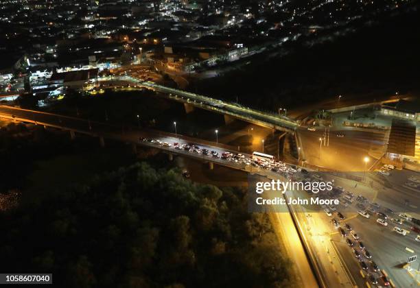 Vehicles wait in line to enter the United States after crossing the international bridge from Mexico , on November 6, 2018 in Hidalgo, Texas. The...