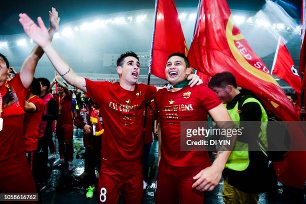 Oscar and Elkeson de Oliveira Cardoso of Shanghai SIPG celebrate after winning the Chinese Super League championship against Beijing Renhe during the...
