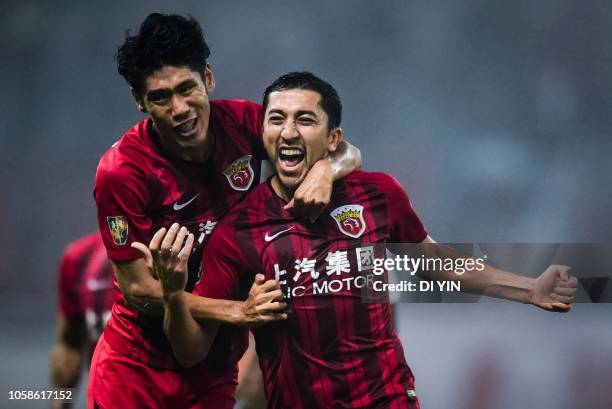 Akhmedov of Shanghai SIPG celebrates a goal with Lyu Wenjun during the 2018 Chinese Super League title match between Shanghai SIPG v Beijing Renhe at...