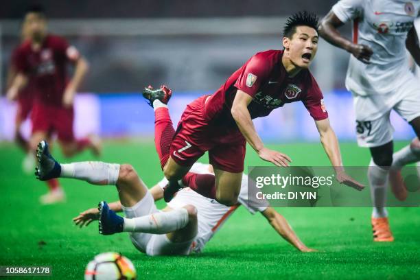 Wu Lei of Shanghai SIPG is tackled during the 2018 Chinese Super League title match between Shanghai SIPG v Beijing Renhe at Shanghai Stadium on...