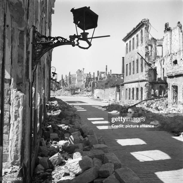 The photo by famous photographer Richard Peter sen. Shows a destroyed wall lantern on a ruin in the cleared Jakobsgasse in Dresden, Germany. The...