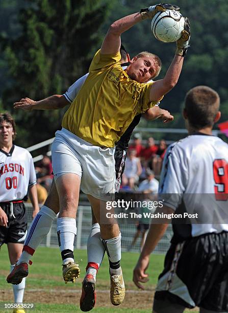 Another save by Radford's GK Adam Dunn jumps up to grab this Mason side kick just as Geoge Mason's Andrew Arias tries to head this ball into the goal...