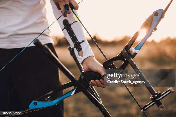 training with bow and arrow - bow and arrow stock pictures, royalty-free photos & images