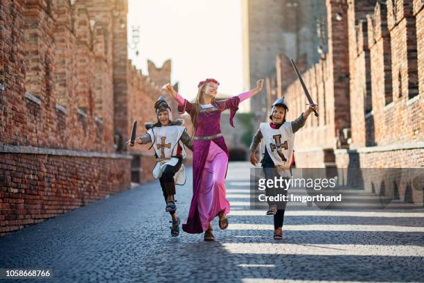 princes and her knights running through castle courtyard - princess stock pictures, royalty-free photos & images