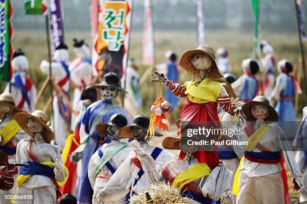 Traditional scarecrows adorn the circuit entrance during previews to the Korean Formula One Grand Prix at the Korea International Circuit on October...