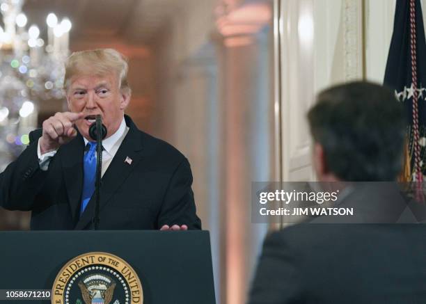 President Donald Trump points to journalist Jim Acosta from CNN during a post-election press conference in the East Room of the White House in...