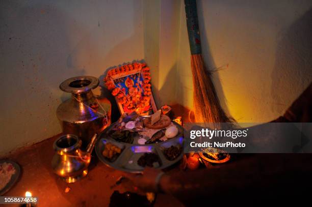 Nepalese devotee offering ritual prayer towards a poster of Laxmi Puja during the procession of Tihar or Deepawali and Diwali celebrations at...