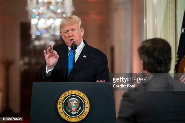 President Donald Trump gets into an exchange with CNN reporter Jim Acosta during a news conference a day after the midterm elections on November 7,...
