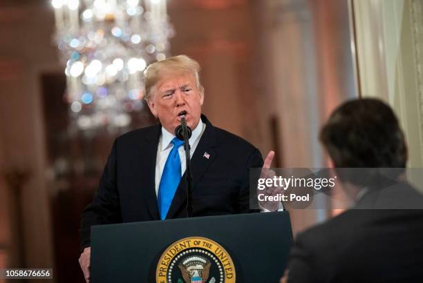 President Donald Trump gets into an exchange with CNN reporter Jim Acosta during a news conference a day after the midterm elections on November 7,...