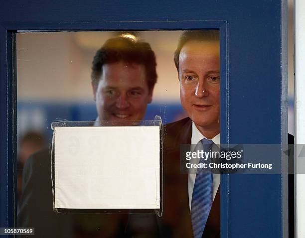 Prime Minister David Cameron and Deputy Prime Minister Nick Clegg arrive to chat to year six pupils during a visit to Welbeck Primary School on...