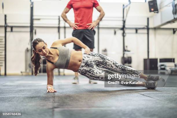 young couple is doing cross training  exercise together - side plank pose stock pictures, royalty-free photos & images