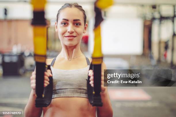 young woman is doing cross training  exercise - suspension training stock pictures, royalty-free photos & images
