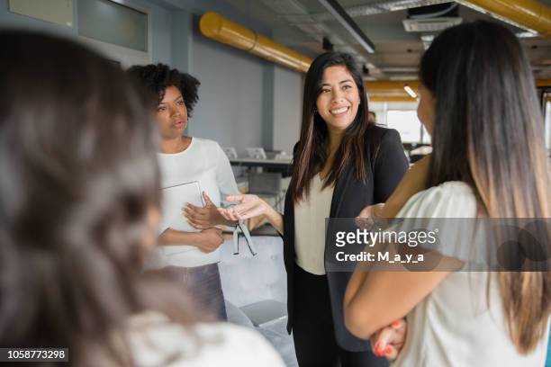 group of women having informal conversation - social issues stock pictures, royalty-free photos & images