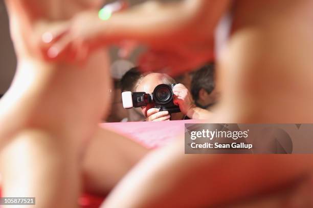 Visitors photograph strippers performing on the industry professionals' day at the 2010 Venus Erotic Fair at Messe Berlin on October 21, 2010 in...