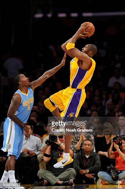 Kobe Bryant of the Los Angeles Lakers shoots under pressure over J.R. Smith of the Denver Nuggets during the preseason game on October 16, 2010 at...