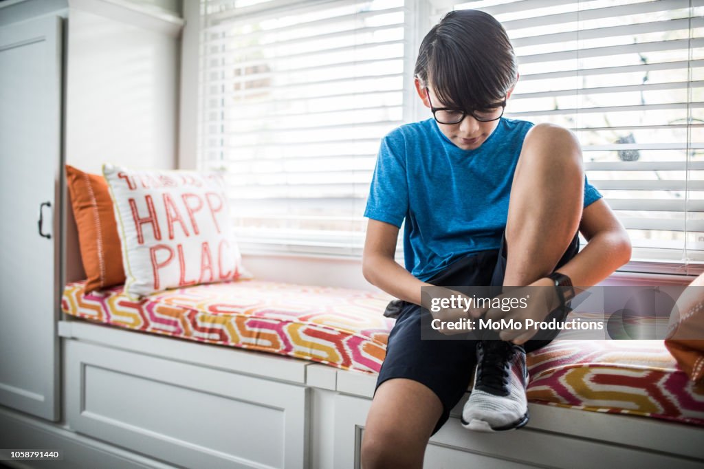 Boy (11yrs) getting ready for school at home