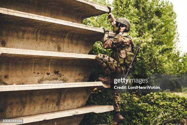 soldier in action - airsoft gun stock pictures, royalty-free photos & images