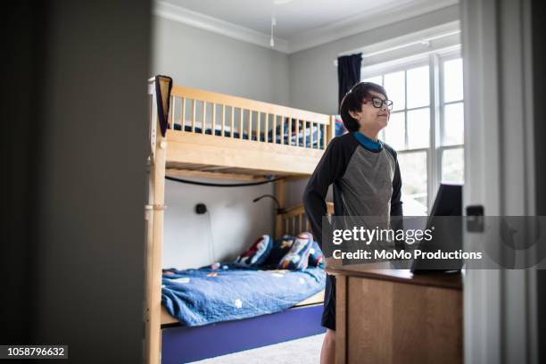 school age boy getting dressed for school at home - kids in bunk bed stock pictures, royalty-free photos & images