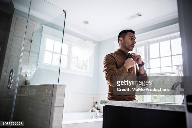 man getting dressed for work at home - preparazione foto e immagini stock
