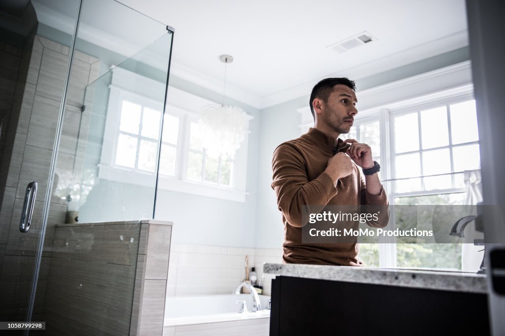 Man getting dressed for work at home