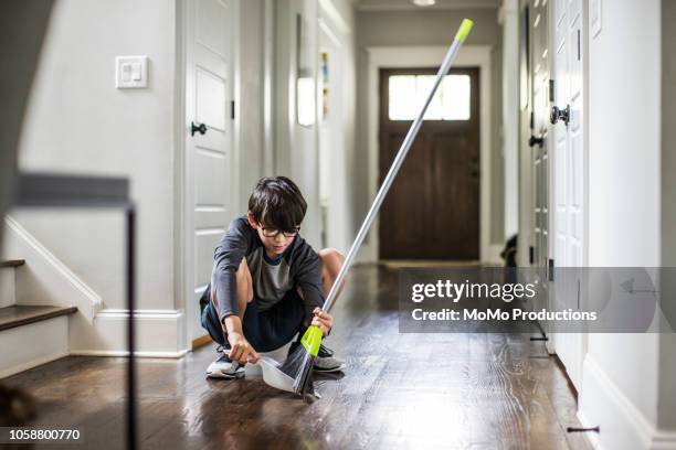 young boy doing cleaning and doing chores - domestic chores photos et images de collection