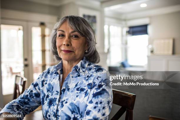 portrait of senior woman sitting on porch - latin american and hispanic ethnicity - fotografias e filmes do acervo