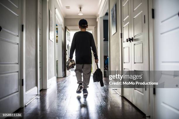 young boy leaving for baseball practice - corridoio oggetto creato dalluomo foto e immagini stock