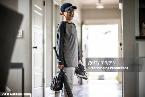 Young boy leaving for baseball practice