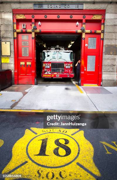 new york, ny: firetruck in squad 18 firehouse - firefighter logo stock pictures, royalty-free photos & images