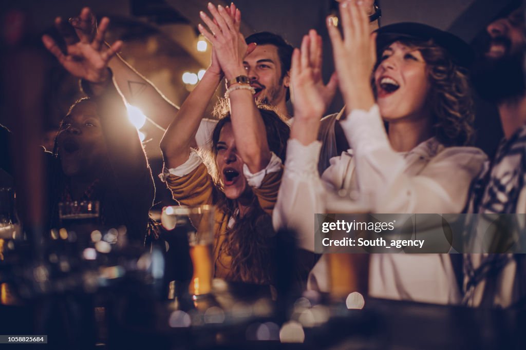 Friends in pub watching match