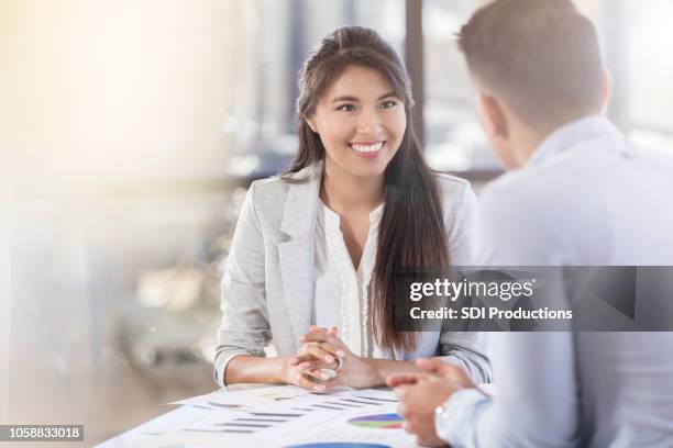 female accountant smiles at her colleague during financial meeting - accounting stock pictures, royalty-free photos & images