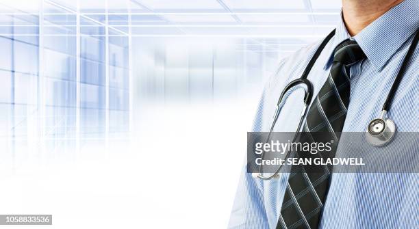doctor wearing shirt and tie with stethoscope - family doctor stock pictures, royalty-free photos & images