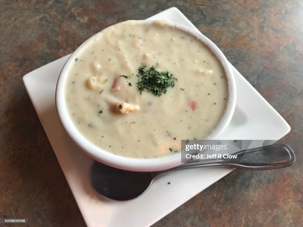 Fresh large bowl of clam chowder with spoon