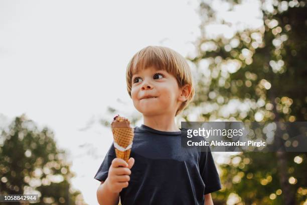 happy boy with an ice cream outside - ice cream imagens e fotografias de stock