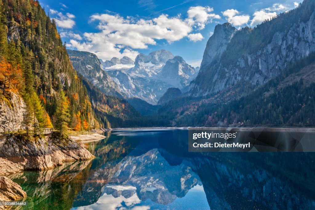 View of idyllic colorful autumn scenery with Dachstein mountain at lake Gosau