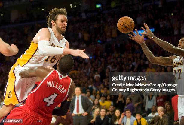 Los Angeles Lakers' Pau Gasol is fouled by the Atlanta Hawks' Paul Millsap at Staples Center in Los Angeles, CA on November 2, 2013. Gasol was fouled...