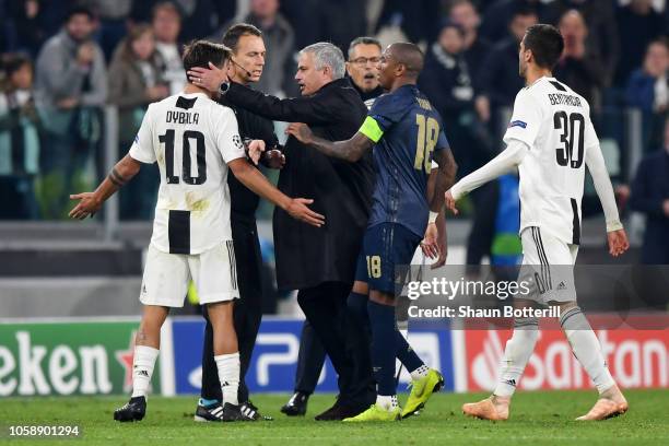 Jose Mourinho, Manager of Manchester United confronts Paulo Dybala of Juventus as Ashley Young of Manchester United holds him back during the UEFA...