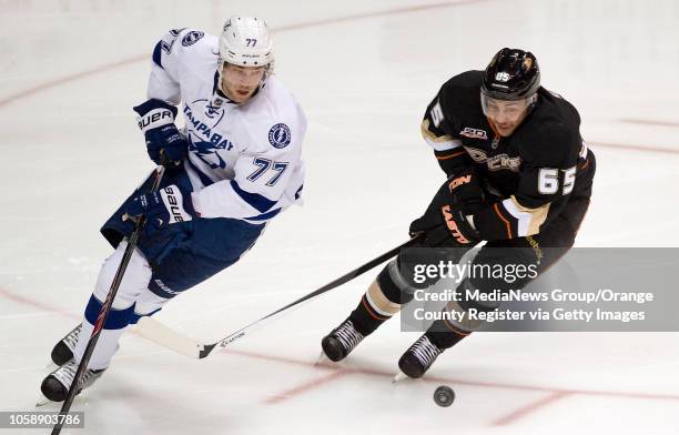 The Ducks' Emerson Etem chases the puck with the Tampa Bay Lightning's Victor Hedman at Honda Center in Anaheim on November 22, 2013.